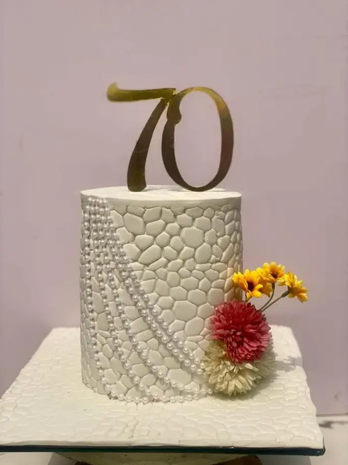 White textured "70" birthday cake
